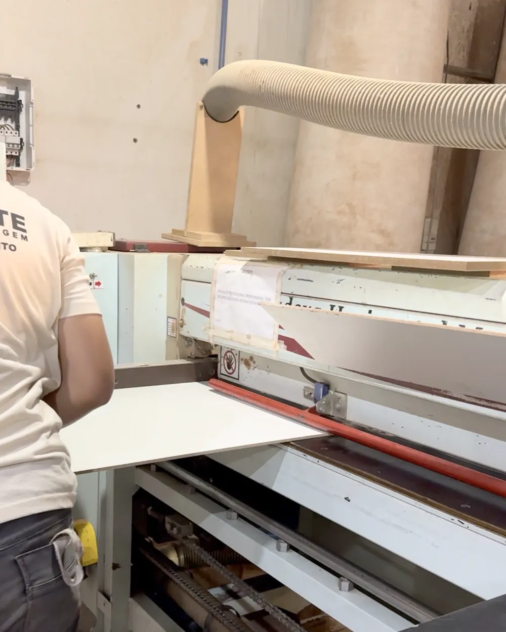 Operador cortando chapa de MDF na seccionadora